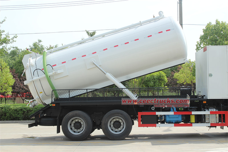 Cesspit emptier truck with tanker lifting and rear door open